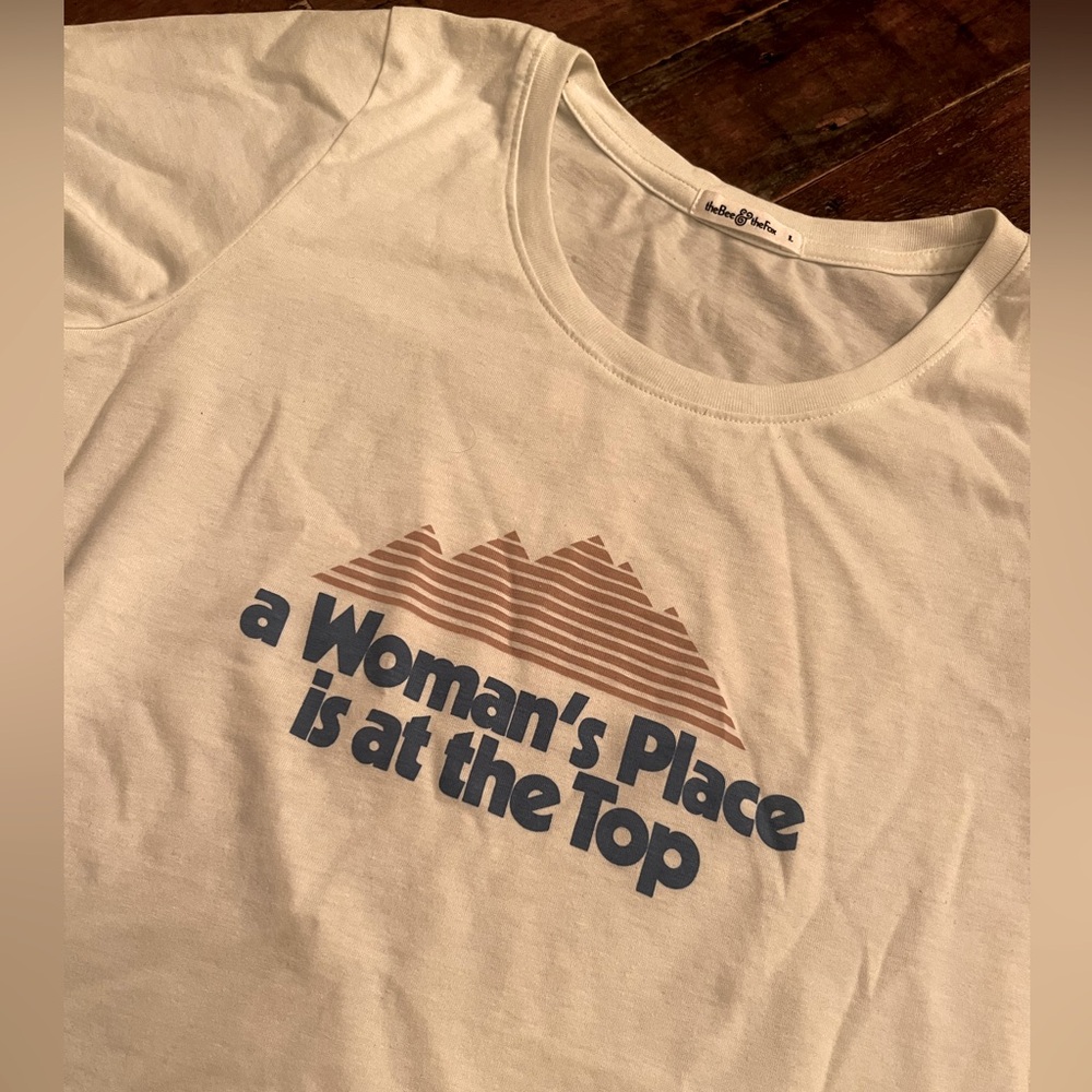 “A Women’s Place is on Top” fitted t-shirt. Perfect layered under a blazer